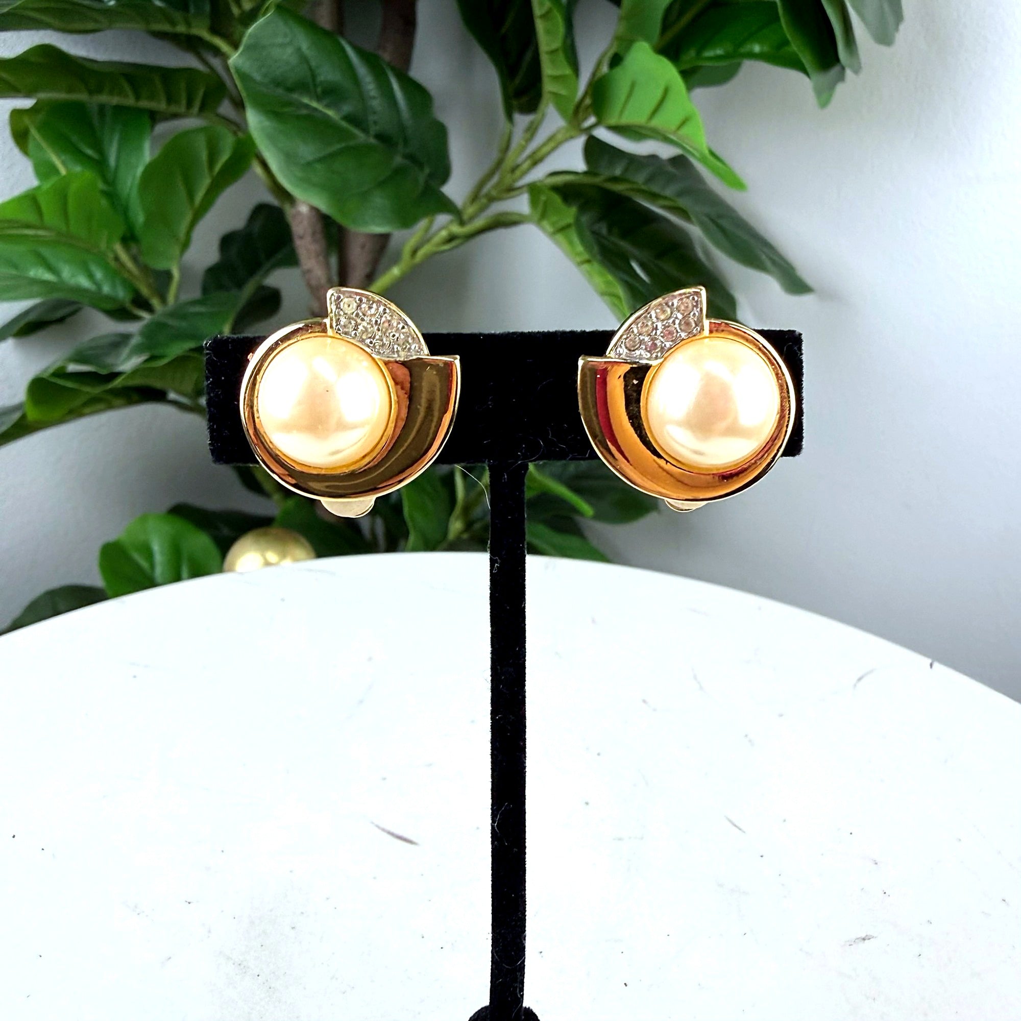 Authentic Givenchy gold-tone pearl clip-on earrings, front view on display stand