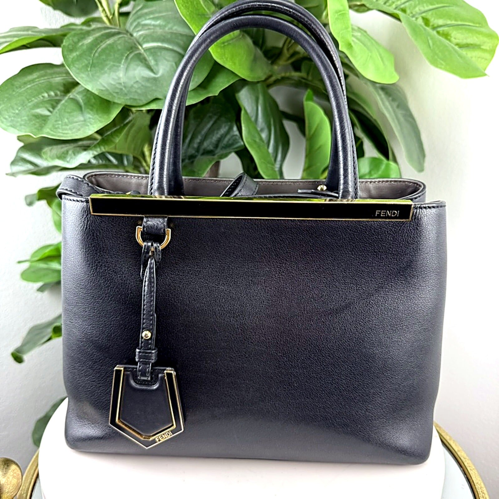 Authentic Fendi 2Jours Petite black leather tote bag - front view with gold FENDI bar clasp and shield charm