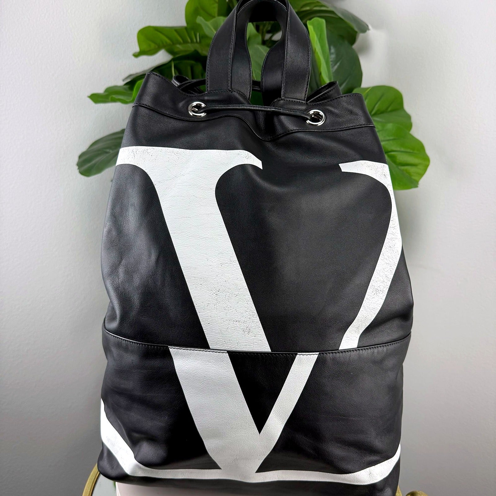 Authentic Valentino Garavani VLTN black leather bucket backpack front view