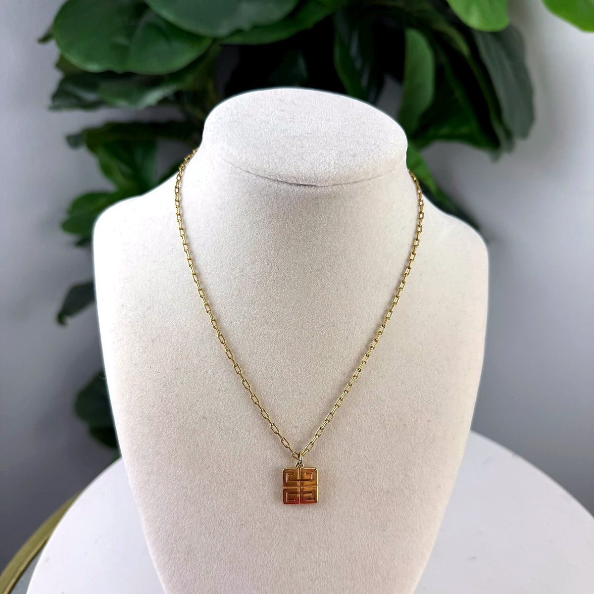 Authentic Givenchy Gold-Tone Square Logo Pendant Necklace front view on bust