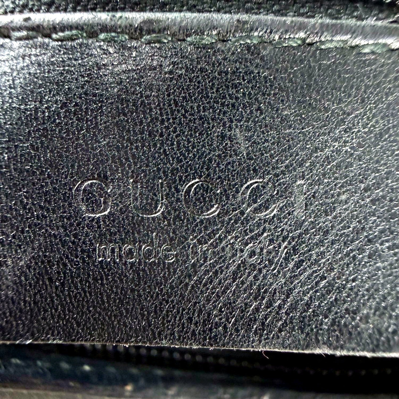 Macro shot of Gucci made in Italy stamped leather tag