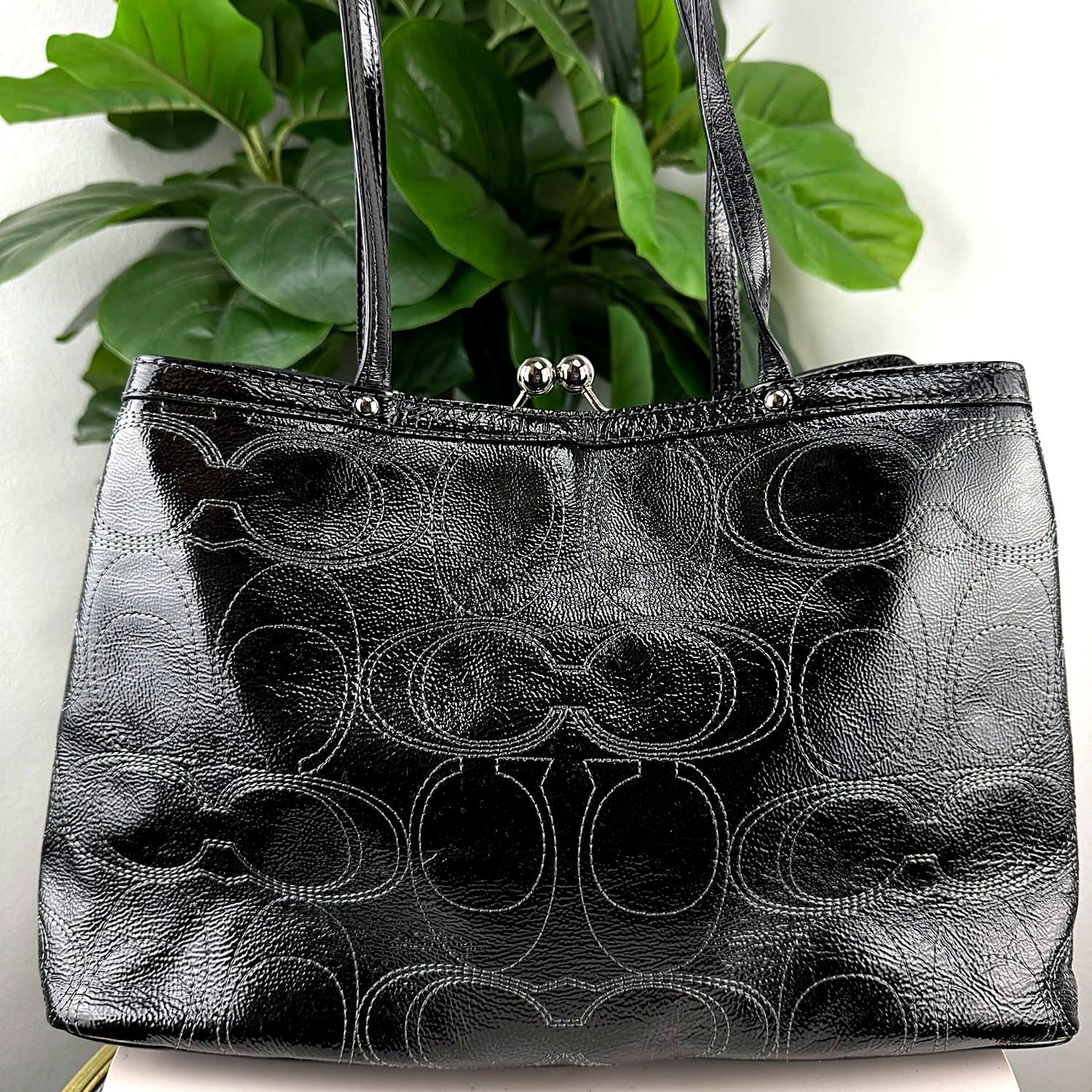 Authentic Coach black patent leather tote with kiss-lock frame closure, front view