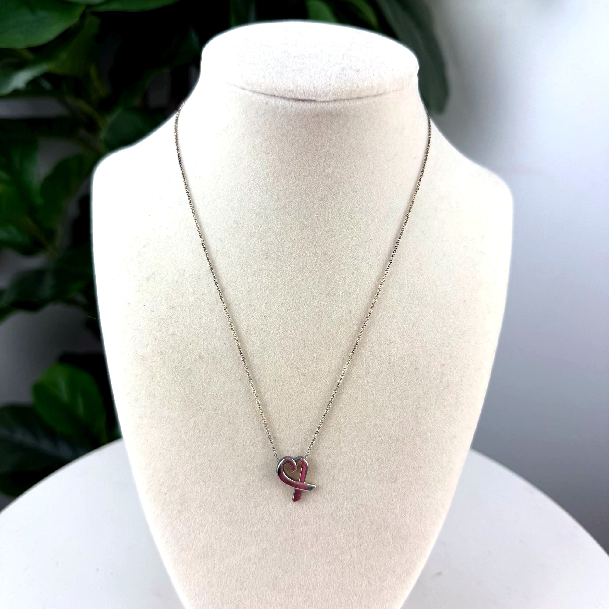 Authentic Tiffany & Co. sterling silver heart ribbon pendant necklace, front view on bust form