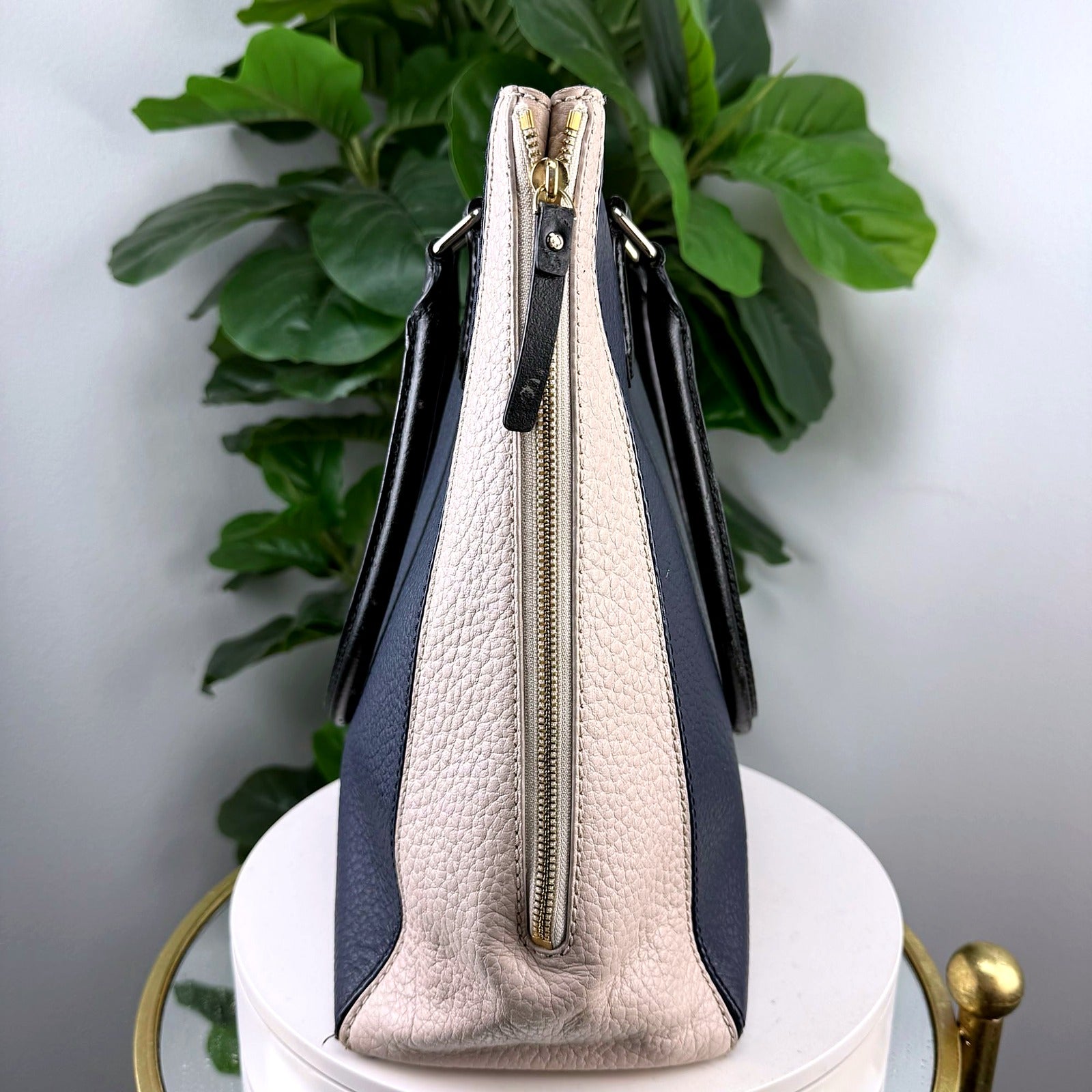 Side view showing zip closure and colorblock gusset