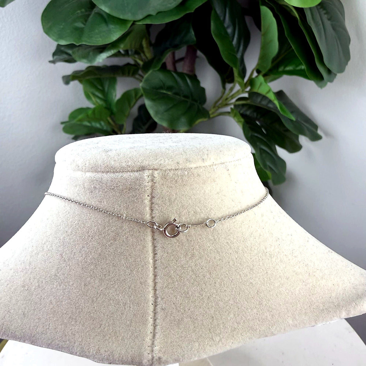 Close-up of spring-ring clasp closure on silver-tone chain