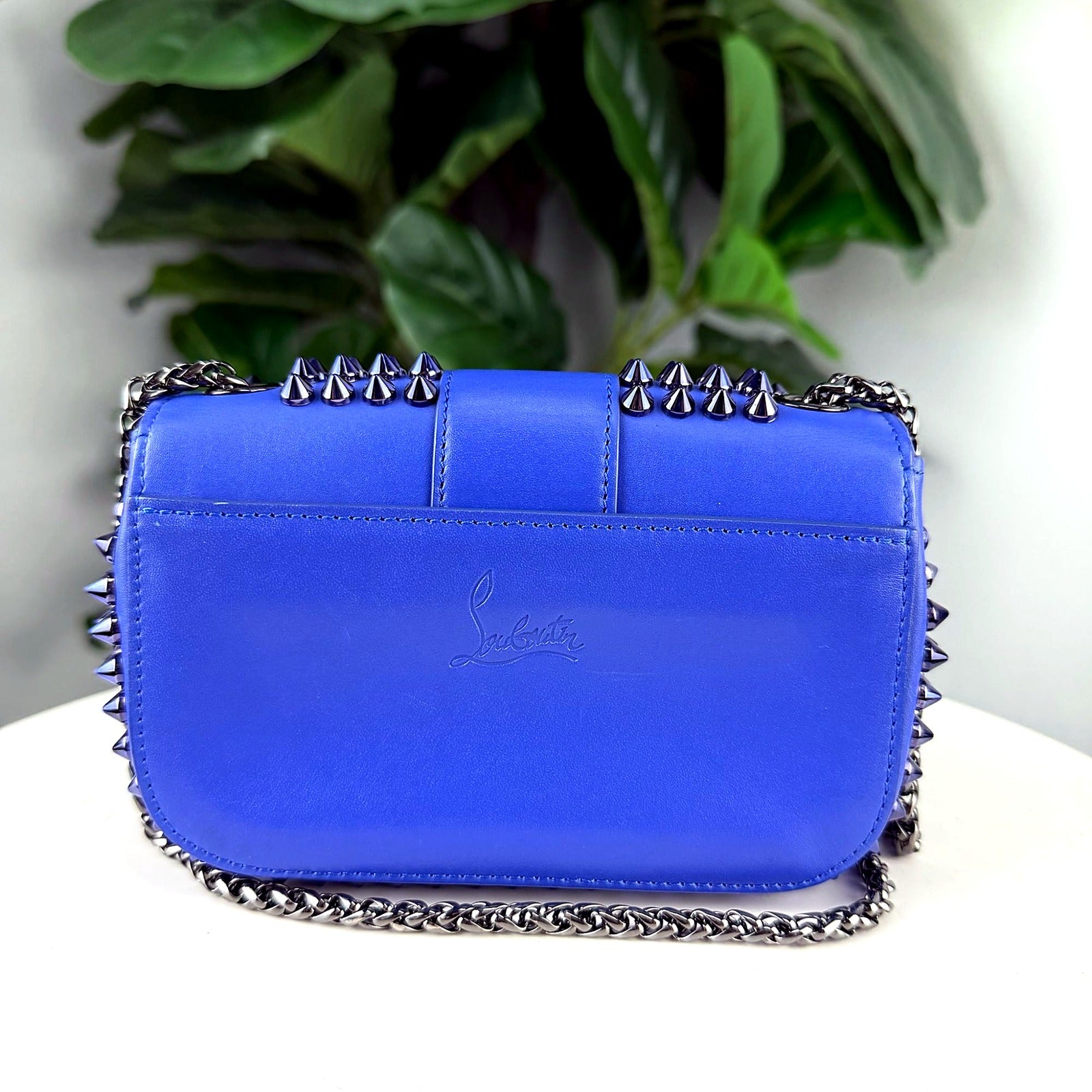 Authentic Christian Louboutin Sweet Charity blue spiked crossbody bag - back view with embossed logo