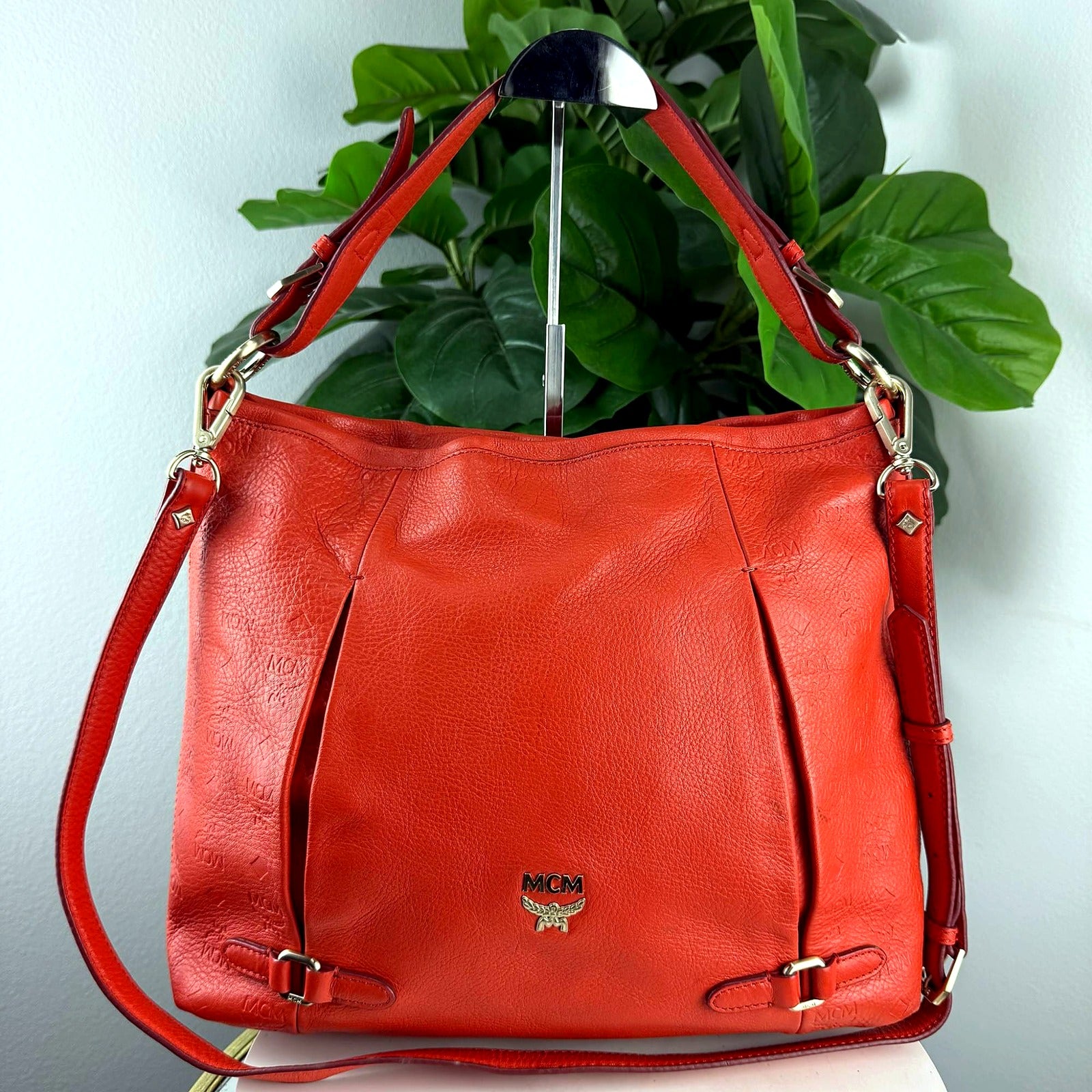 Authentic MCM red embossed monogram pleated hobo bag - front view