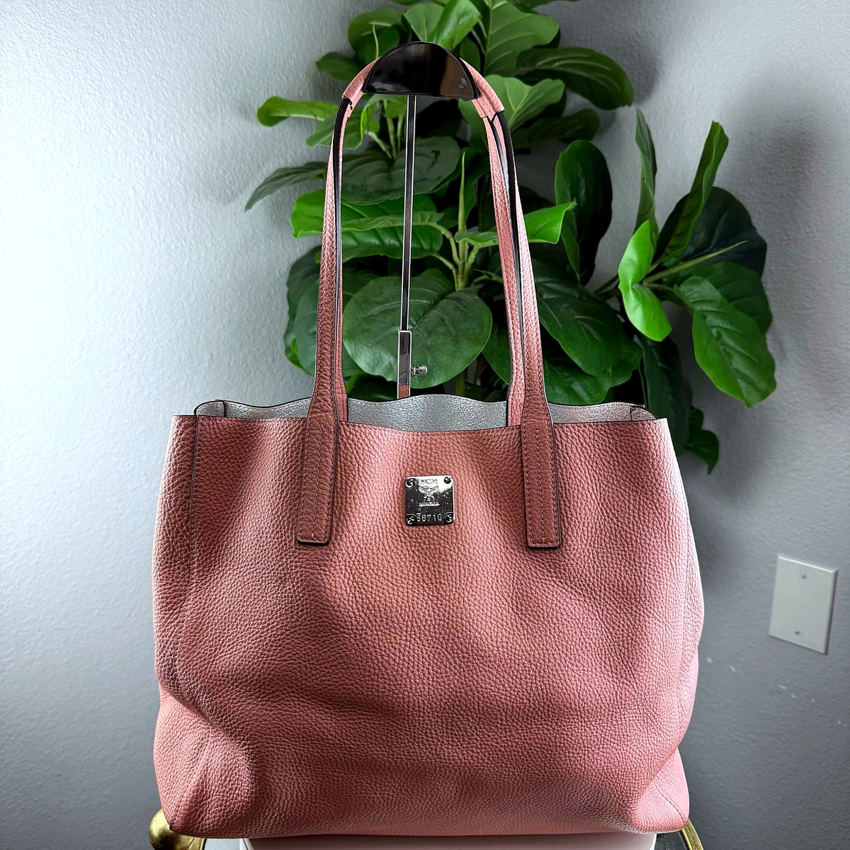 Authentic MCM dusty rose pebbled leather tote bag, front view on display stand