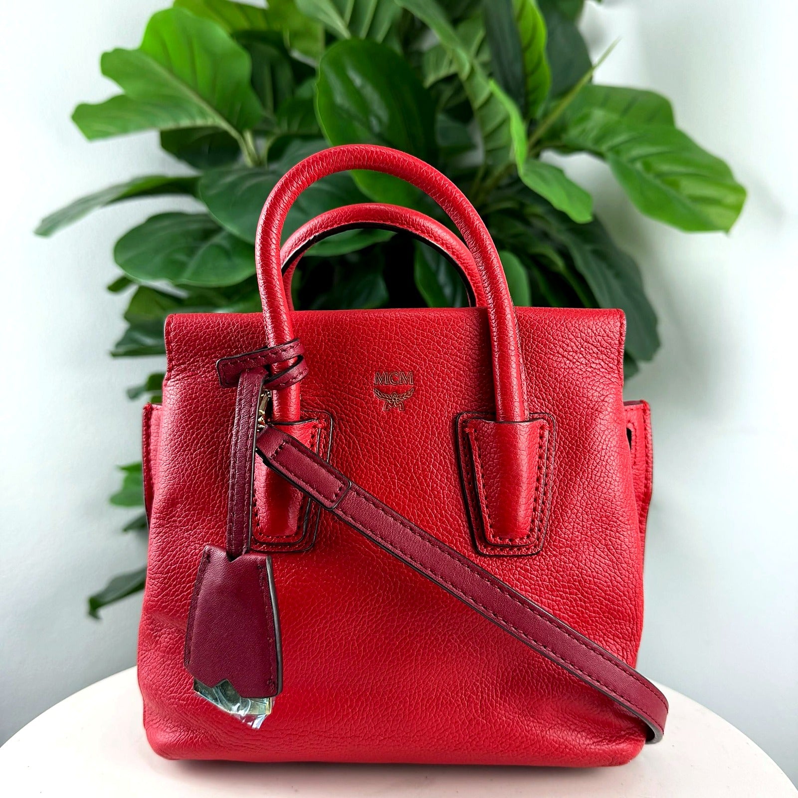 Authentic MCM red pebbled leather top handle bag - front view